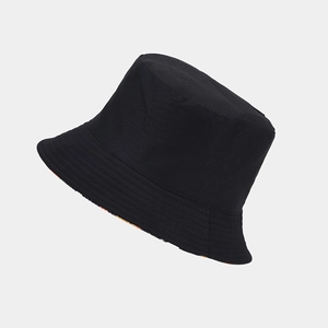 Detail of black cotton bucket hat with parallel stitching on brim and orange pattern lining