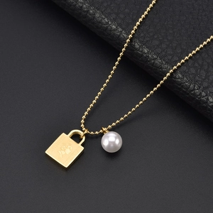 Golden bead chain necklace with pearl and Elizabeth II portrait lock pendant on leather
