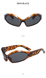 Detail of retro wide-leg sunglasses with demi-black frame and dark grey lenses