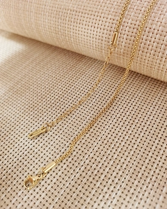 Detail of gold stainless steel necklace chain with lobster clasp and S.STEEL tag