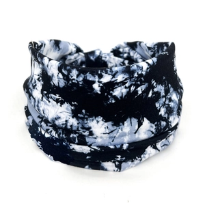 Close-up of black and white tie-dye stretchy cotton headband with paisley pattern texture