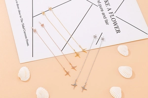 Three pairs of long heartbeat drop earrings in gold, rose gold, and silver finishes
