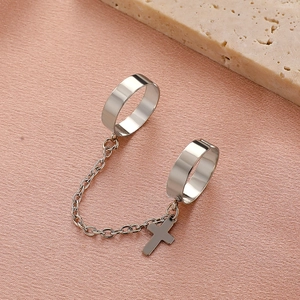 Silver double ring set with delicate metal chain and tiny cross pendant detail