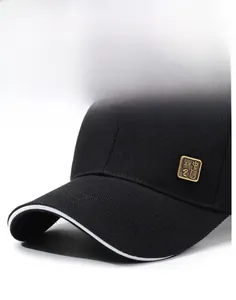 Detailed close-up of a black cotton baseball cap featuring a golden metal logo plate