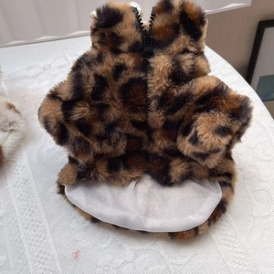 Close-up of leopard print plush pet vest featuring black resin zipper and soft white lining