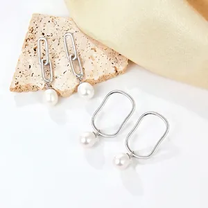 925 silver drop earrings with natural white pearls on silk and stone background