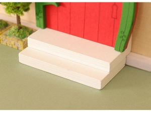Close-up of white wooden miniature stairs for dollhouse DIY Christmas scene decor