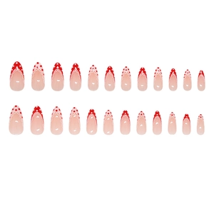 French tip press on nails with red polka dots and white lace on almond shaped gradient base