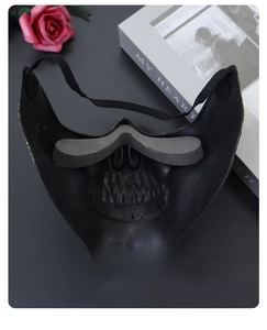 Detail of internal foam padding and elastic strap on a black skull half-face mask