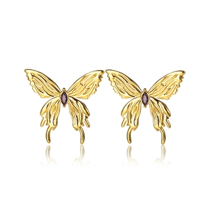 Golden butterfly stud earrings with purple gemstones and polished finish on white backdrop