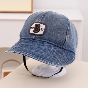 Detailed view of kids denim sun hat featuring white BEST letter embroidery and windproof strap