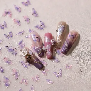 Detail of 3D embossed butterfly nail stickers with gold outlines and purple floral motifs