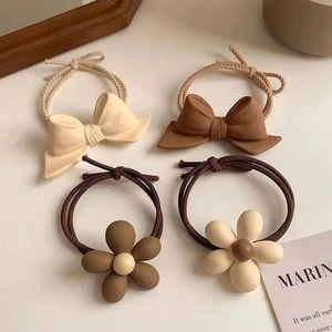 Set of 4 elegant bow and floral hair ties in beige and brown matte resin finish