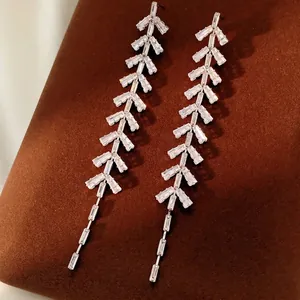 Silver fringe leaf earrings with baguette-cut zircons for elegant evening look