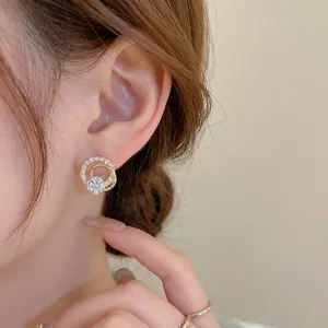 Elegant gold plated silver stud earrings with sparkling cubic zirconia double rings