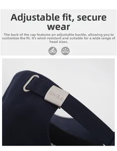 Detail view of adjustable metal buckle with laser engraved logo on navy cotton baseball cap