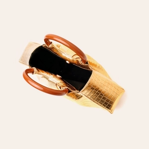 Top view of gold crocodile texture clutch with vintage wood handle and spacious interior