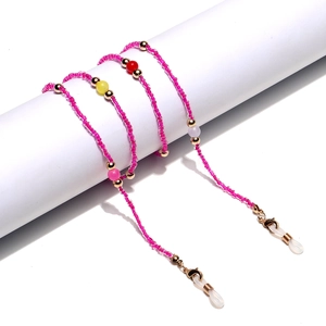 Pink beaded glasses chain with colorful beads and silicone loops on white display stand