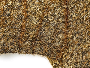 Macro texture of black bomber jacket fabric woven with metallic gold thread filaments