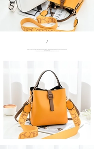 Detail of yellow bucket bag featuring contrast brown handle and patterned wide strap