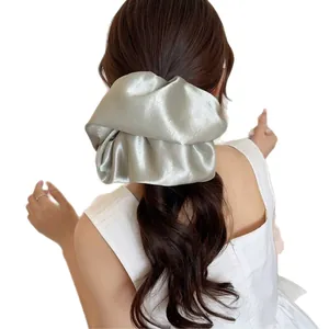 Oversized sage green satin scrunchie for women with elegant pleated texture and metallic luster