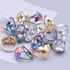 Adjustable geometric heart rings in gold, silver, and rainbow steel, stacked on a gray surface