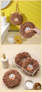 Macro shot of fluffy brown lion chenille hand towel ball with hanging loop for bathroom