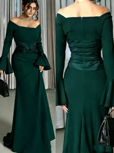 Detail of the off-shoulder neckline and bell sleeves on a dark green mermaid party dress
