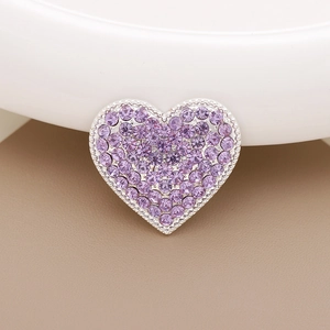 Macro shot of silver heart charm with pavé purple crystals for shoe charms and DIY decor