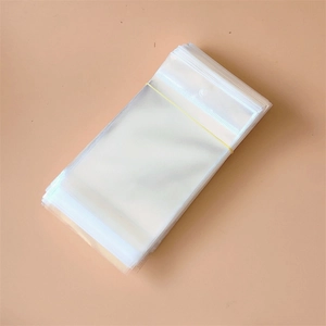 Close-up of clear self-sealing plastic jewelry bags stacked with a rubber band