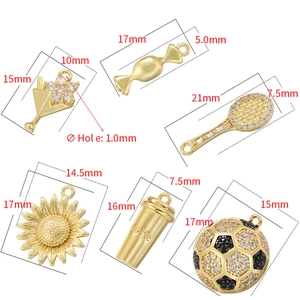 Selection of gold-plated charms including coffee cup and sports icons for jewelry making