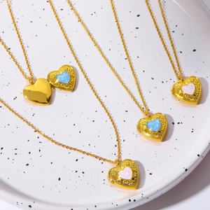 Macro shot of open and closed heart locket necklaces with blue and pink opal stones