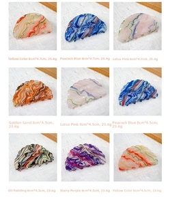 Detailed grid of oil painting style hair claws in various marbled acetate finishes