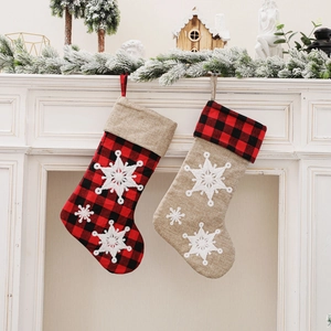 Red buffalo plaid and beige linen Christmas stockings with white snowflake embroidery