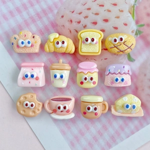 Detailed set of 12 mini resin food cabochons for DIY crafts on pink plaid background