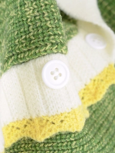 Macro shot of V-neck knit cardigan with green and yellow stripes and white buttons