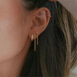 Close-up of gold S925 silver fringe earrings with tassel chain and zircon accents