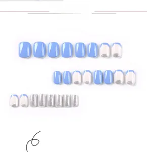 Detail view of 24 pieces of blue and silver glitter press-on nails in various designs
