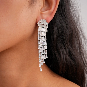 Close-up of model wearing silver tassel earrings with sparkling cubic zirconia stones