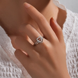 Close-up of S925 sterling silver double heart ring with inlaid diamonds on model finger