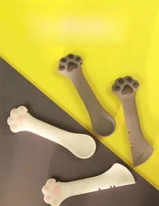Detail of cat claw silicone canning spoon showing its multi-functional scraper and opener edge