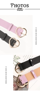Detail of sweet heart-shaped buckle belts with faux pearls in black and lavender colors