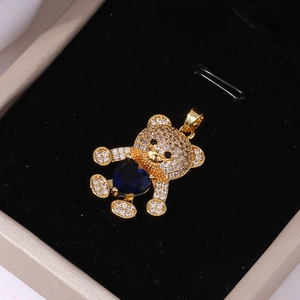Golden bear pendant with blue heart zircon and pavé crystals in a black jewelry box