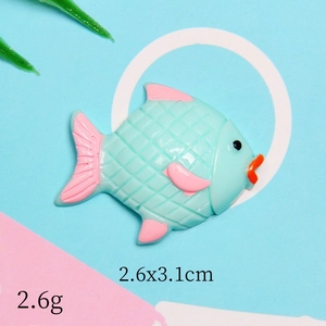 Macro view of mint green and pink resin fish charm with 2.6x3.1cm dimensions