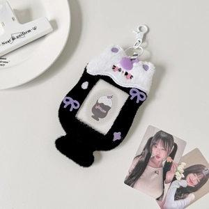 Detail of plush black and white cat photo card holder with purple bow and star embroidery