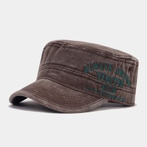 Detail view of vintage dark brown cadet cap with high-quality green embroidery on side