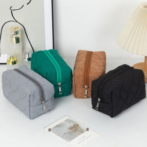 Quilted cosmetic bags set in four colors with square stitching and metal zippers