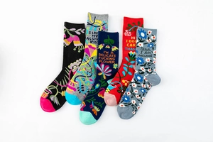 Detailed view of five pairs of vibrant cotton socks with floral patterns and slogans