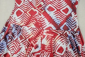 Detailed view of gathered waist stitching on geometric print halter maxi dress