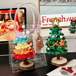 Close-up of DIY plush Christmas tree on wood base with decorative gingerbread ornaments